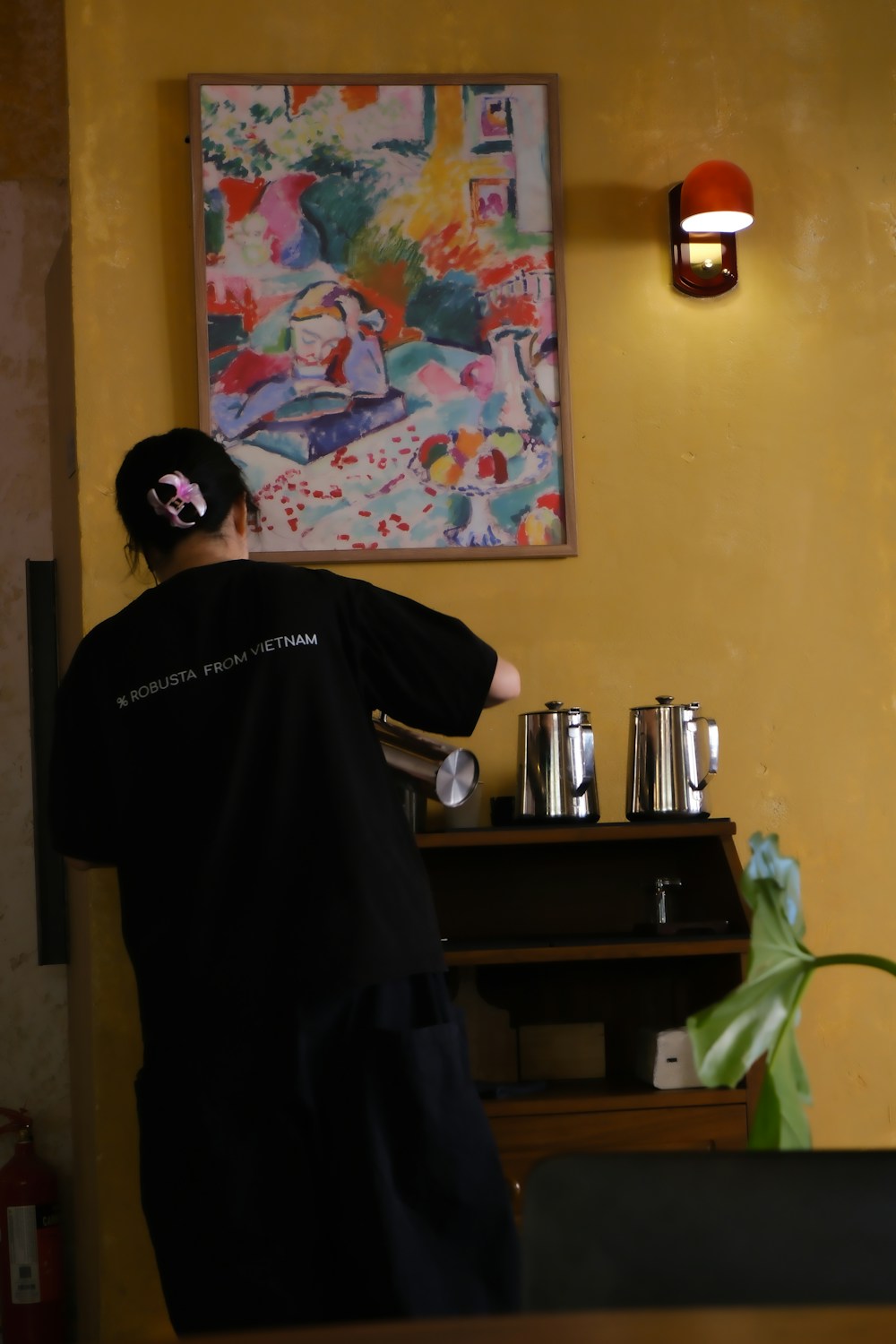 A café team member preparing drinks behind the counter